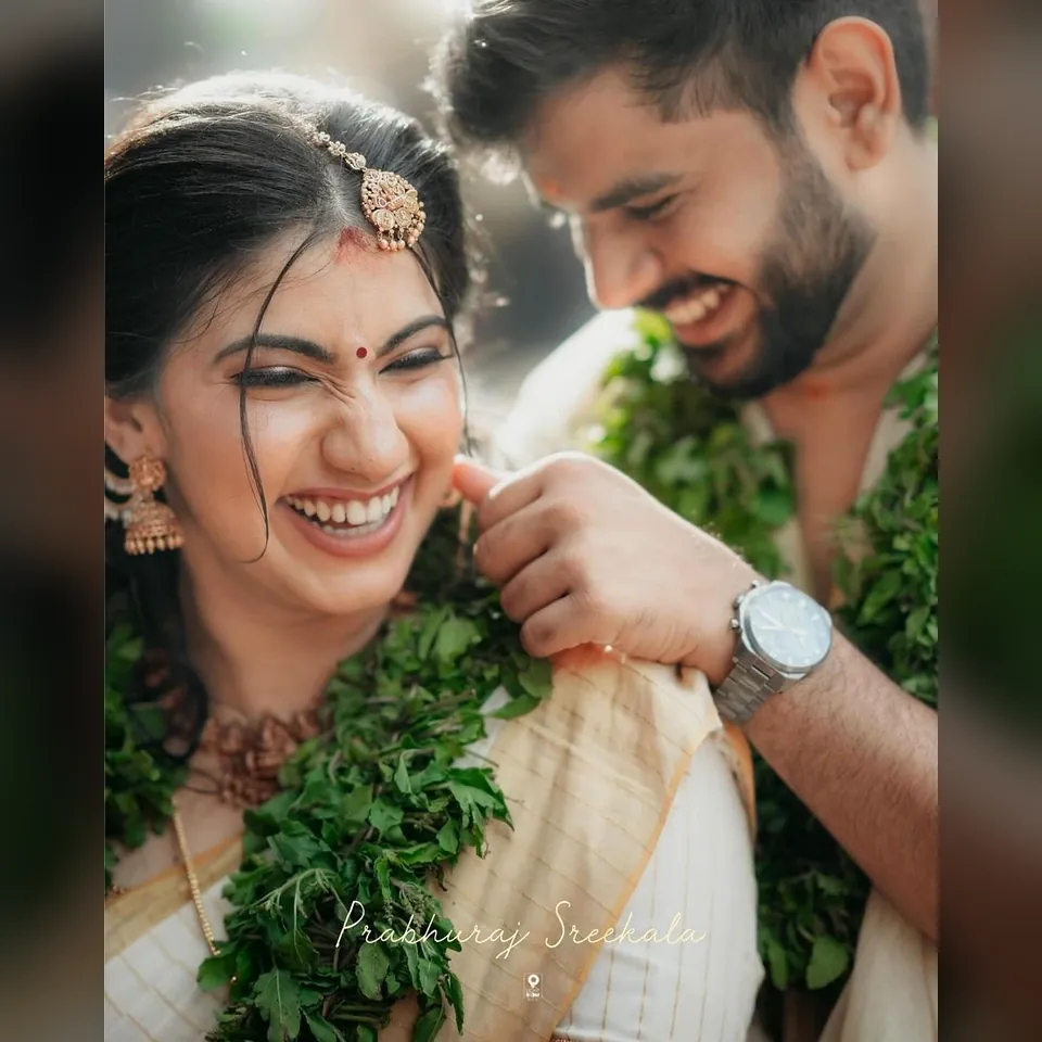 Smiling South Indian wedding couple sharing a joyful moment