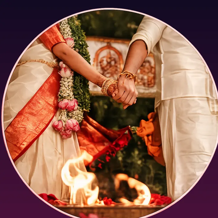 Traditional Tamil wedding couple holding hands near the sacred fire